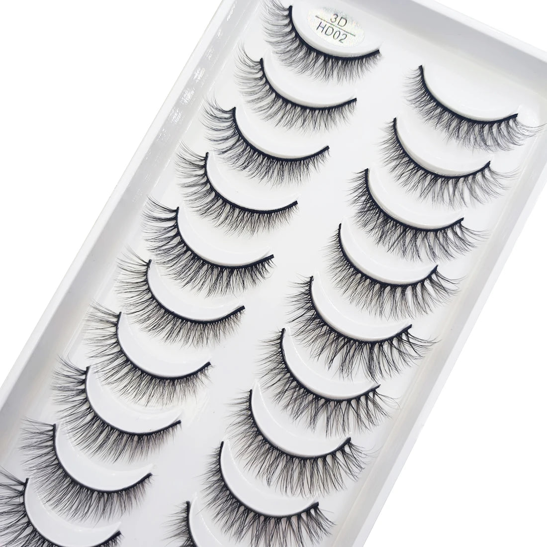 A plastic tray containing multiple pairs of natural 3D mink false eyelashes for eye makeup.