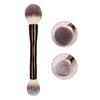 A double-ended makeup brush set featuring soft, fluffy brushes in a taupe or gray color.