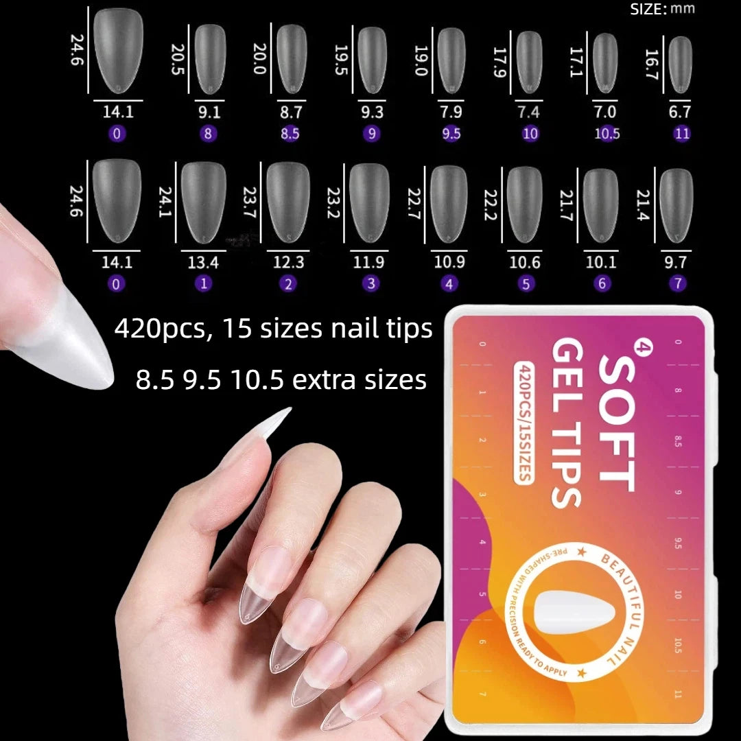 A hand holds a box of soft gel nail tips showing various sizes and shapes for acrylic nails.