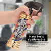 A hand holds a gold-colored bottle with a black pump dispenser, featuring a barber shop design.