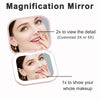 Miroir de toilette pliable rose compact montrant le visage d'une femme, démontrant des fonctionnalités de grossissement.