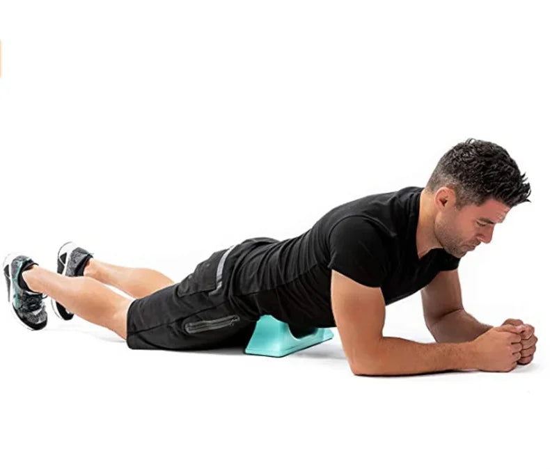 A man is using a Psoas Muscle Massager for deep tissue release on his leg.
