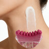 A pink natural rubber gua sha tool with a textured surface is placed on the skin of a neck.