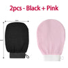Two exfoliating body scrubbing gloves in black and pink shown side by side.