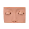 A realistic silicone mannequin head with closed eyes and long eyelashes for eyelash extension practice.