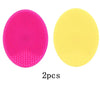 Two silicone facial cleansing brushes, one pink and one yellow, for deep pore cleansing.