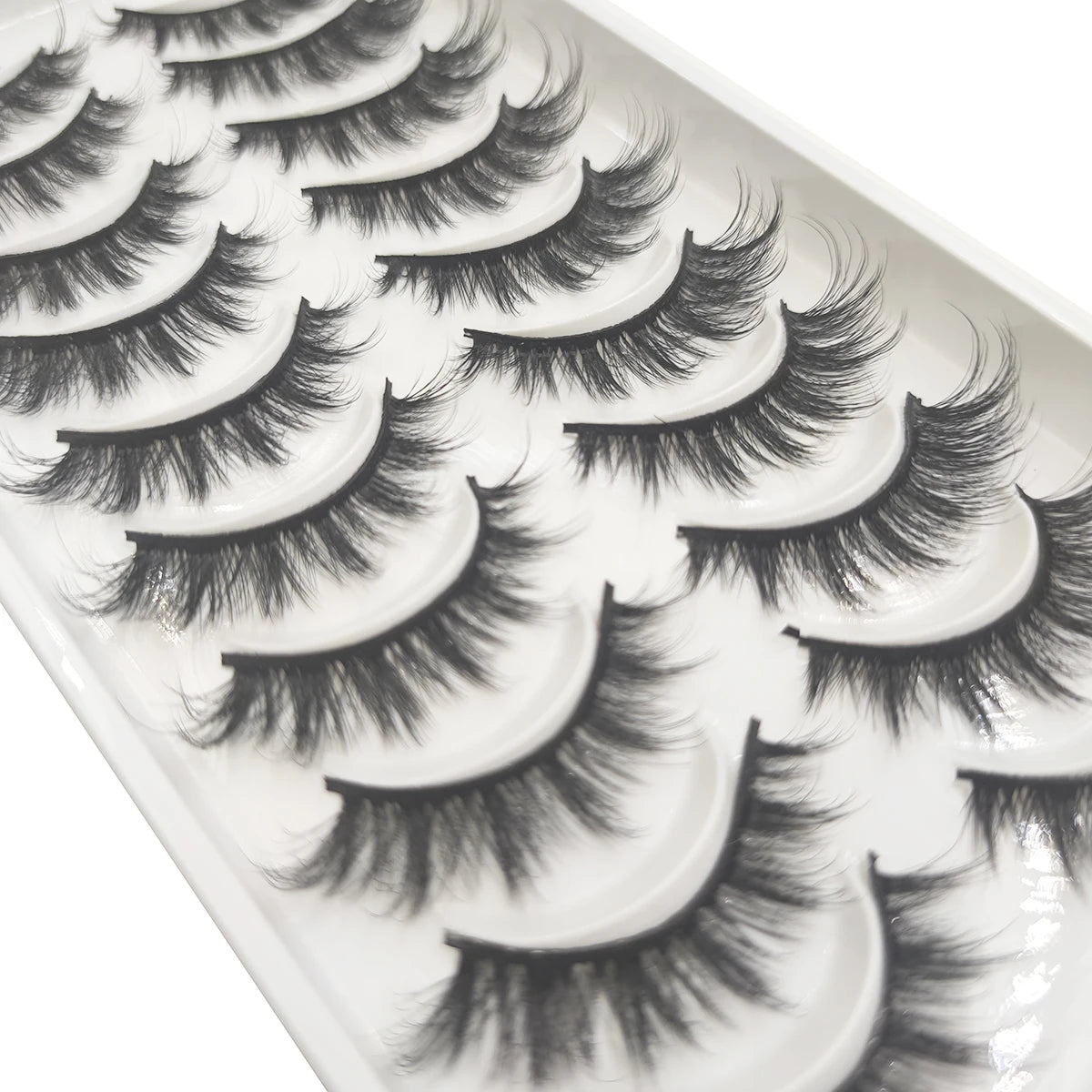 A close-up view of a tray of natural 3D mink false eyelashes.