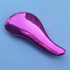 A glossy magenta detangling hair brush is shown against a light blue background.