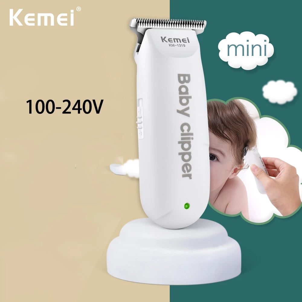 A white Baby clipper hair trimmer is shown on a stand against a green background with a light beige surface.
