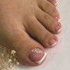 Nahaufnahme eines Fußes mit Nägeln, verziert mit weißen French-Tips und floralen Designs.