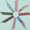 A collection of anti-static rat tail combs in various floral and patterned colors arranged in a circle.