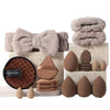 A set of beauty sponges and a bow made of soft, beige-colored material.