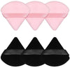 A set of pink and black triangular powder puffs for foundation application.