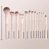 A collection of professional loose powder makeup brushes in various sizes and shades displayed vertically.