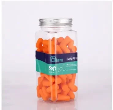 Un pot en verre rempli de bouchons d'oreille orange ultra-doux à réduction du bruit.
