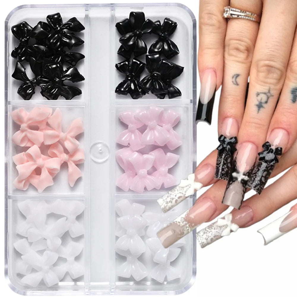 A clear plastic case holds various black and pink 3D floral butterfly pearl nail art charms for fingernails.