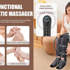 A woman is using a black pneumatic massager on her leg while sitting on a sofa.