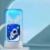 A blue electric toothbrush for kids is shown inside a clear cylindrical device with a glowing light and a white base.
