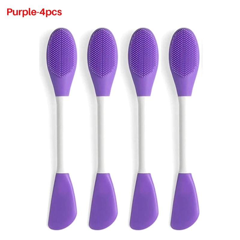 A set of four purple silicone facial brushes for exfoliation