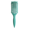 A teal professional curl define styling brush with a flexible silicone comb and tapered handle.