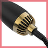 Close-up view of a black hair blow dryer brush with gold accents and a black cord.