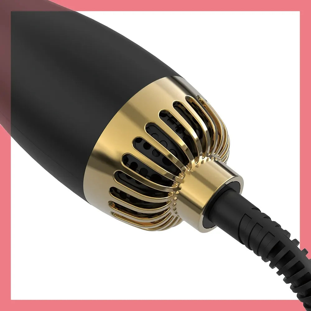 Close-up view of a black hair blow dryer brush with gold accents and a black cord.
