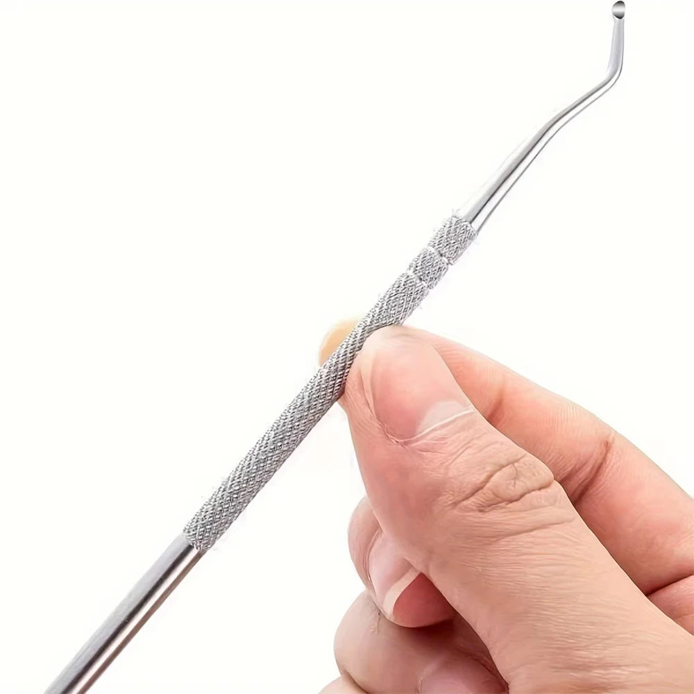 A hand is holding a stainless steel ingrown toenail pedicure tool with a textured grip.