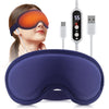 A woman is wearing an orange electric heated eye mask with a silicone strap and a separate control unit.