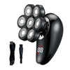 A black electric shaver and grooming kit with five rotating shaving heads shown next to the charging cord.