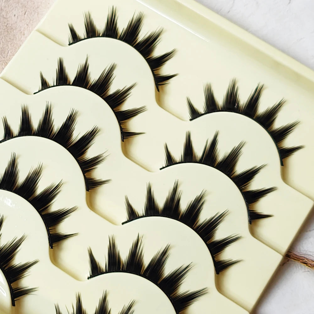 A display of five pairs of long and thick black false eyelashes on a white background.