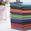 A stack of 10 patterned, colorful ultra soft quick-dry sport towels in various shades of blue, green, purple, and brown.