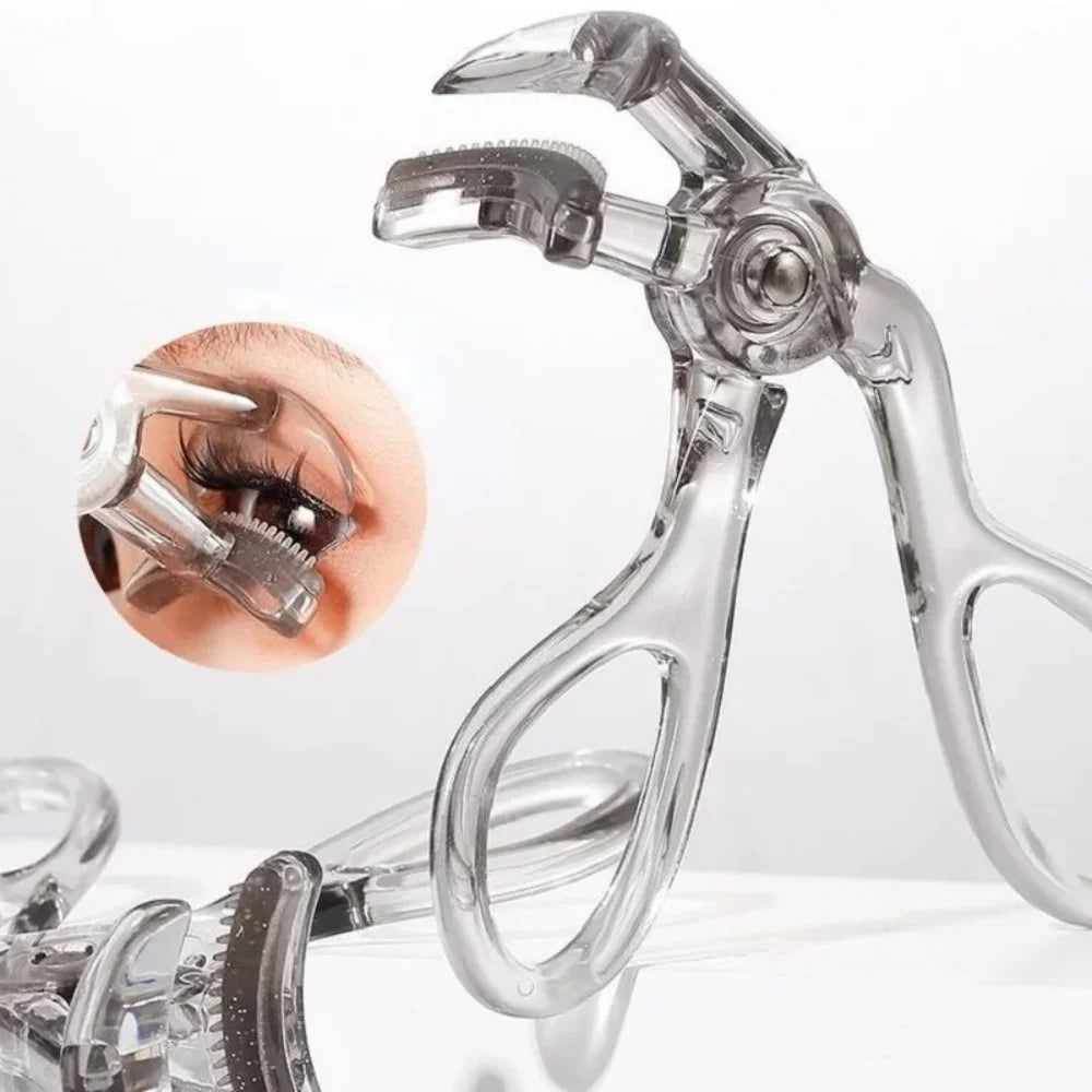 Clear dual-type eyelash curler with comb shown against a white background.