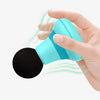 A hand is holding a small, light blue portable massage gun with a black head.