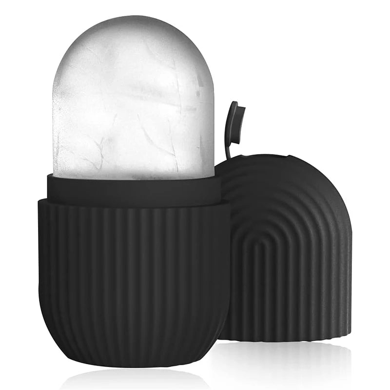 Rouléuse à glaçons en silicone noire avec une tête de pierre arrondie et transparente, sur une surface réfléchissante.