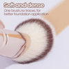 A close-up of a soft and dense makeup brush with light brown bristles used for foundation application.