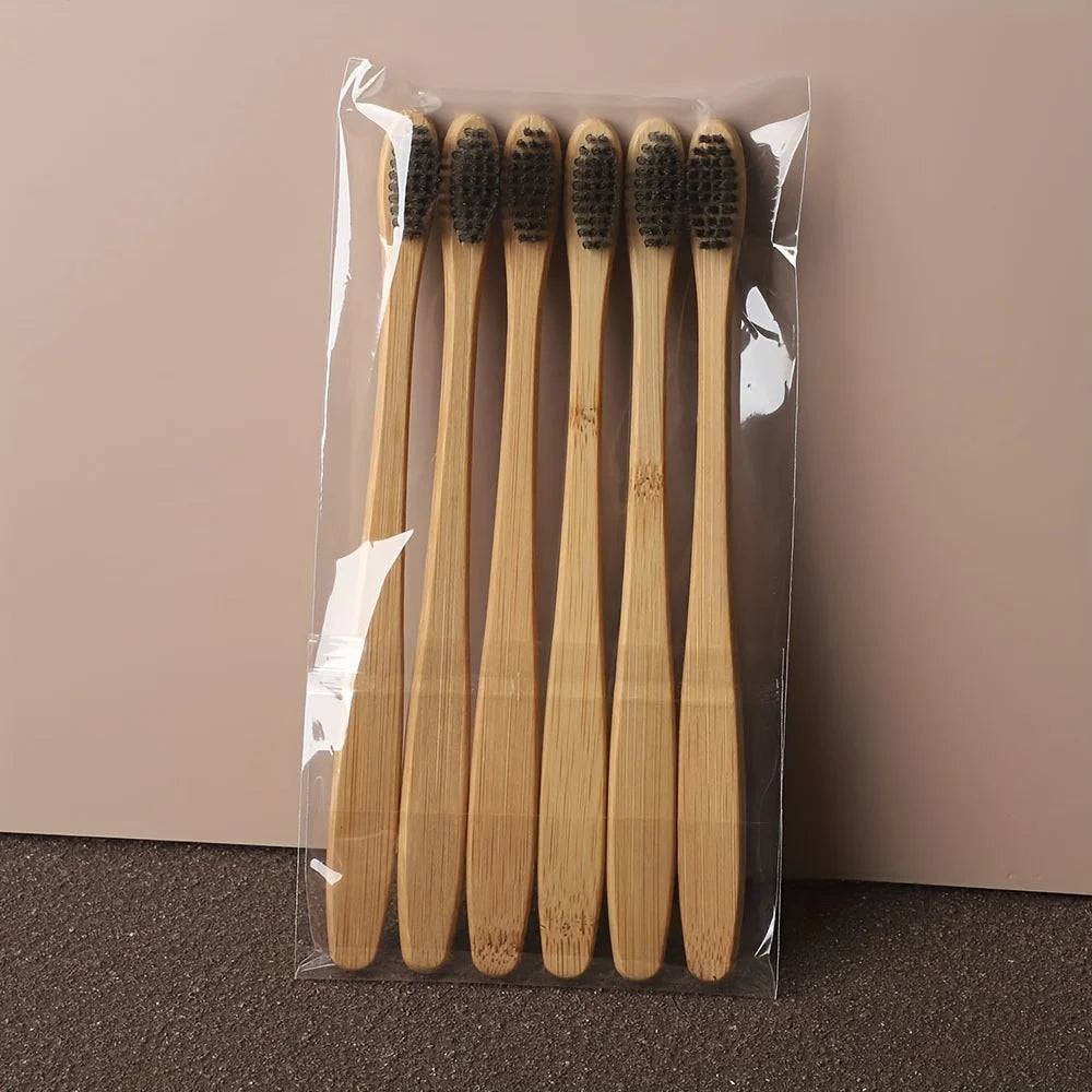 A clear plastic package containing a set of six light brown bamboo toothbrushes.