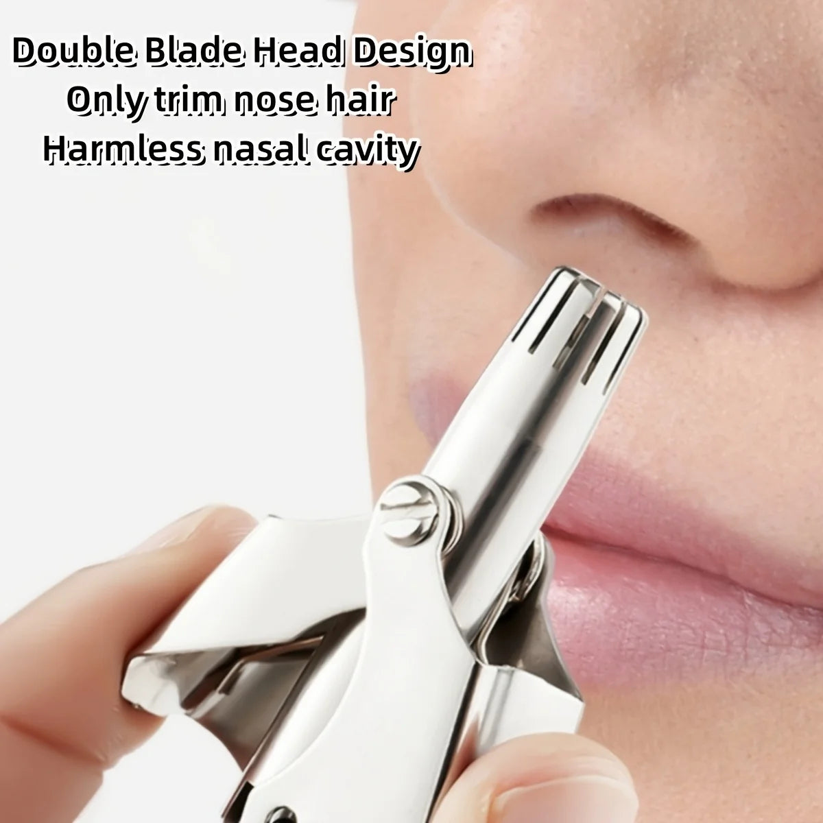 A close-up of a portable stainless steel nose and ear hair trimmer being used on a person's nose.