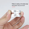 A hand holds a razor blade with a silver coating and the text Super Platinum visible on the packaging.