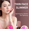 A woman is using a pink facial slimmer device with LED lights for skin tightening.