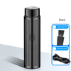 A black portable electric shaver with a cleaning brush and USB charging line visible.