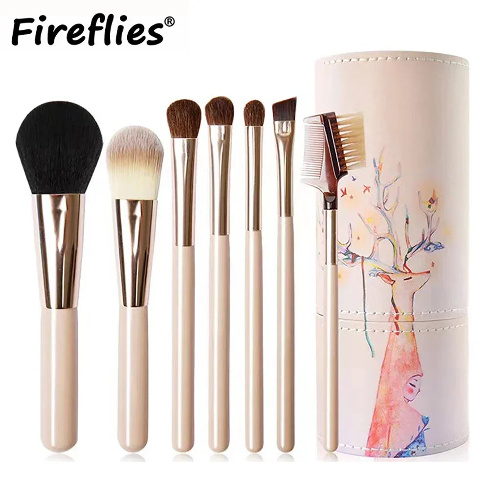 A set of ten professional makeup brushes in various sizes and shades displayed next to a cylindrical container.