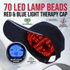 A black cap with red and blue LED light therapy beads is shown, demonstrating the blue light mode.