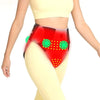 A woman is wearing a red abdominal heating pad designed for pain relief.