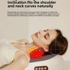 A woman is using a portable shiatsu neck massager pillow for a kneading massage on her shoulder and neck.
