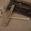 A wooden bamboo toothbrush set with a handle and bristles is displayed on burlap fabric.