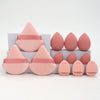 A set of 12 pink makeup sponges in various shapes and sizes displayed on a white box.