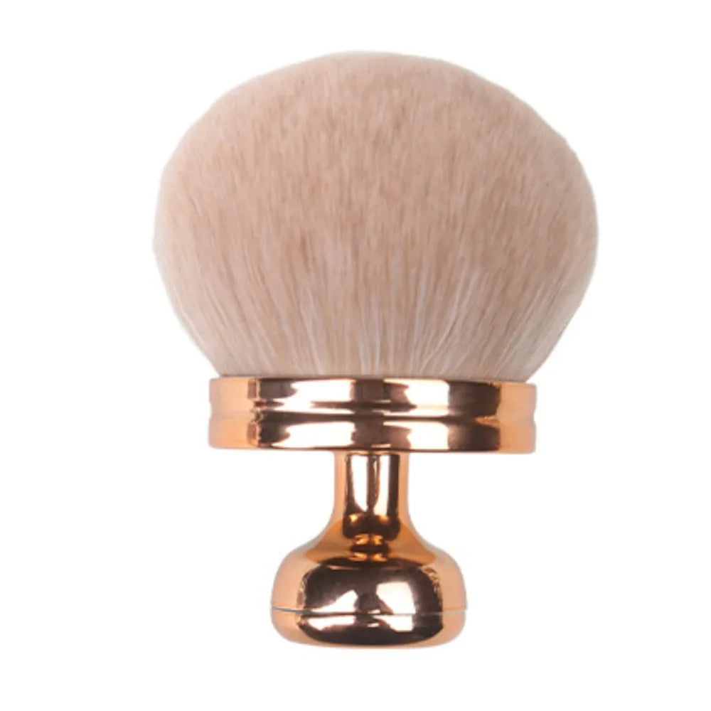 A large, fluffy, beige makeup brush with a gold-toned handle.