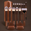 A set of seventeen professional makeup brushes and a travel bag displayed on a brown surface.
