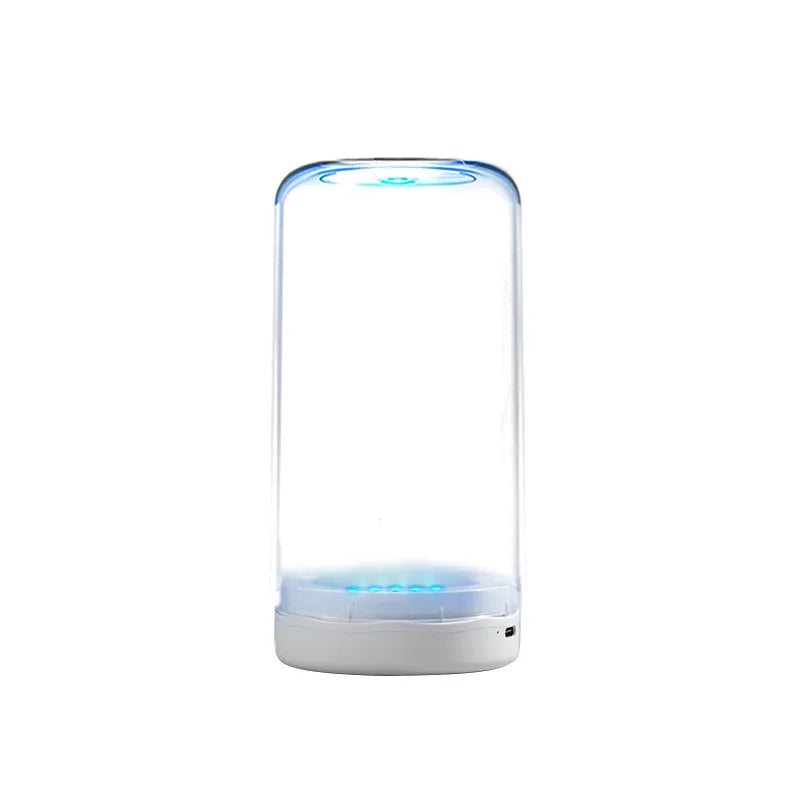 A clear cylindrical electric toothbrush with a blue light feature sits on a white base.