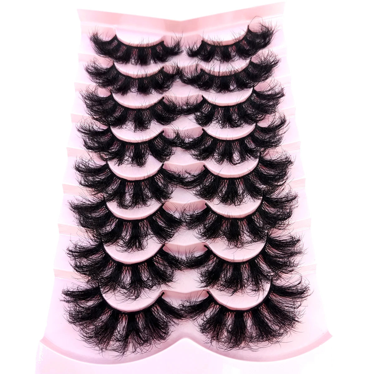 A display of natural mink striped false eyelash extensions arranged in rows on a pink background.